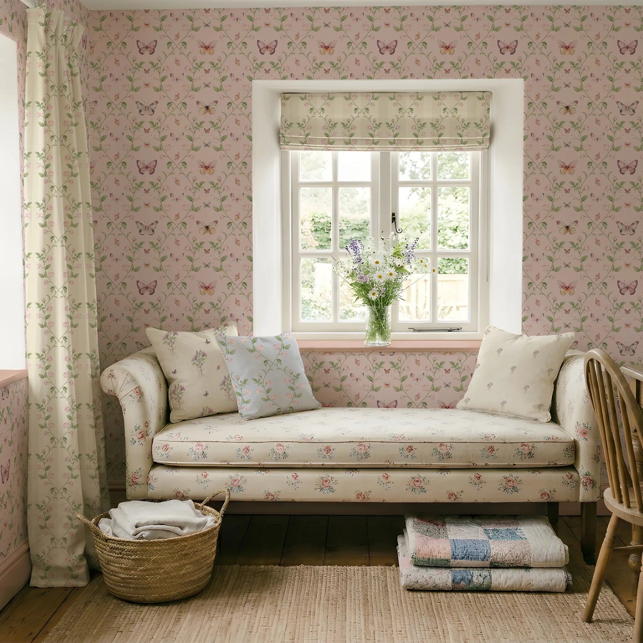Cozy room with floral and butterfly wallpaper, a daybed, and a window with a view of greenery.