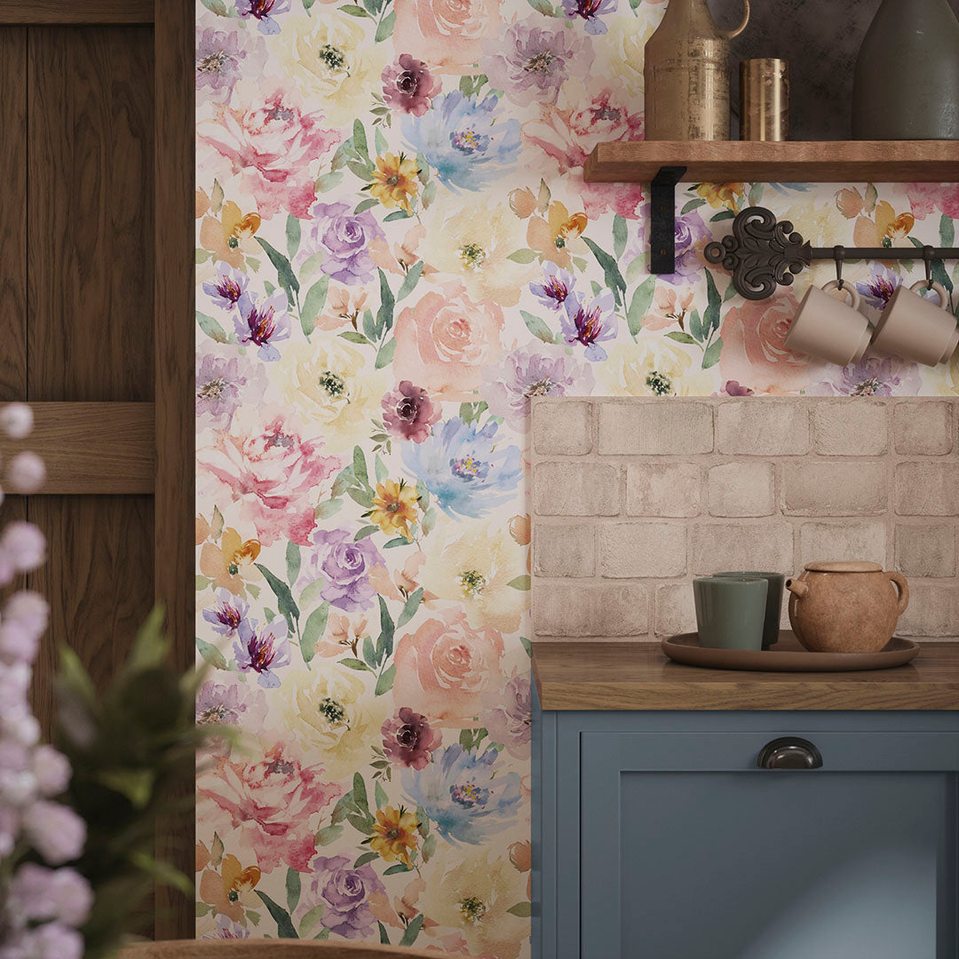 Cottage kitchen wall with wallpaper featuring watercolour-style florals, and wooden worktops. 