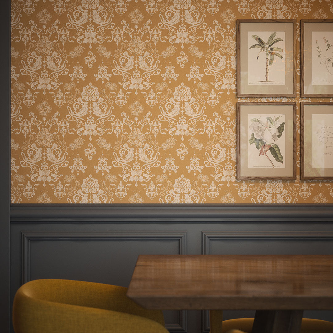 Dining room wall featuring damask wallpaper in oche with white floral motifs. 