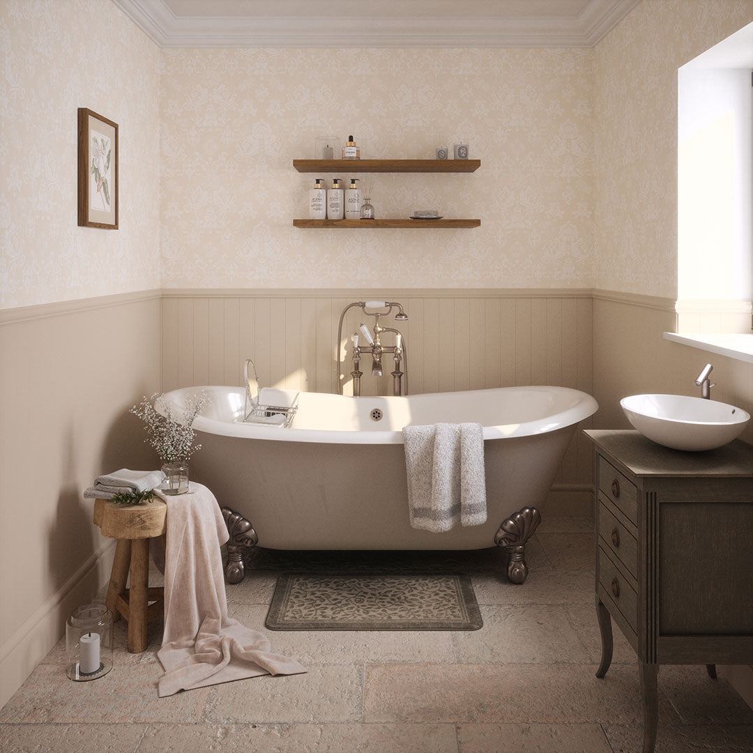 Cottage bathroom setting with half panelled walls in cream, with a cream damask wallpaper featuring floral motifs. 