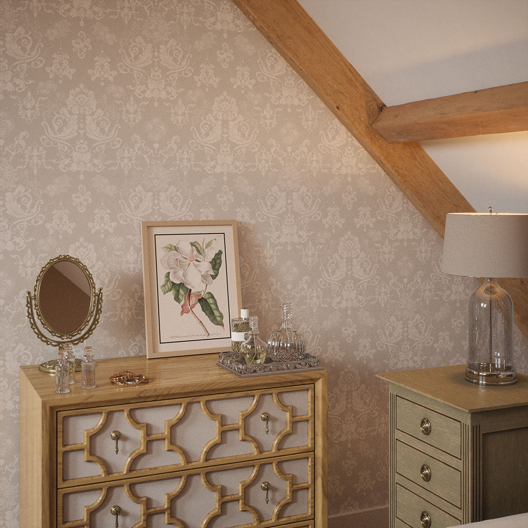 Bedroom nook with wooden beams, drawers, and a light grey damask wallpaper featuring white floral motifs.
