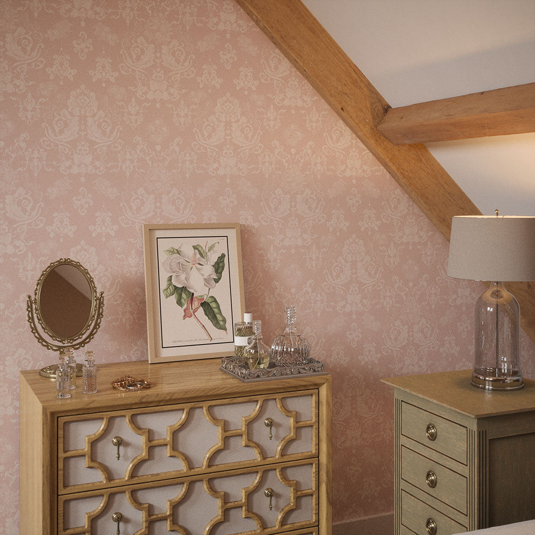 Bedroom nook with wooden beams, drawers, and pink damask wallpaper featuring floral motifs.