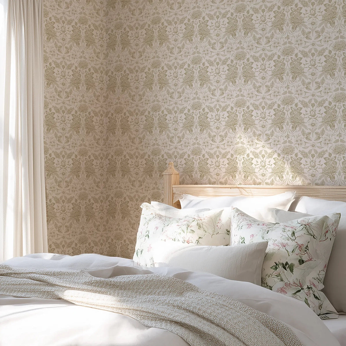 Bedroom with floral wallpaper in beige, and floral-patterned pillows on a bed.