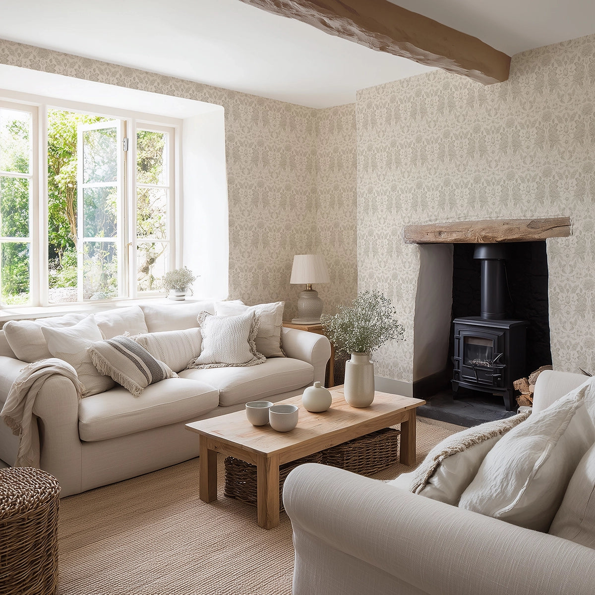 Cosy living room with beige sofas, a wooden coffee table, and a fireplace with beige, floral wallpaper.