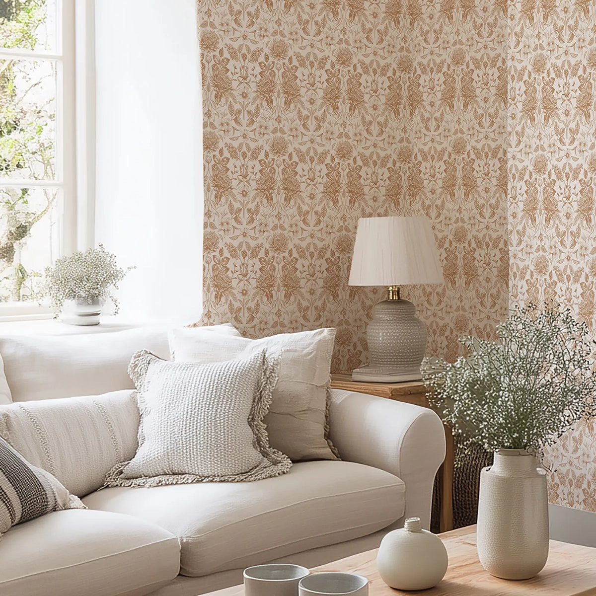 Living room with floral wallpaper in terracotta, beige sofa, decorative pillows, and a lamp against a patterned wall.