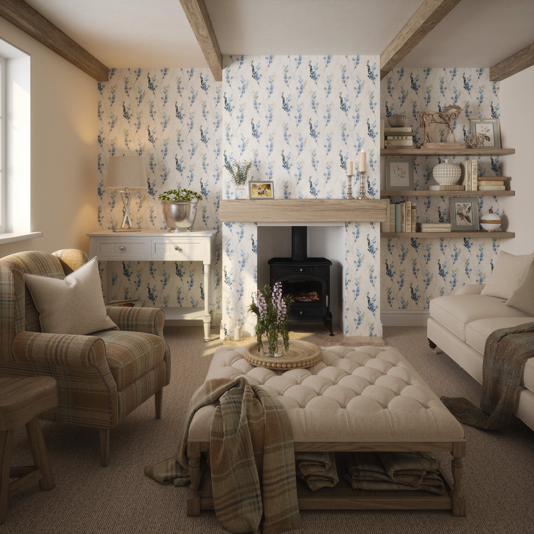 Cottage living room setting with soft furnishings and fabrics featuring blue floral wallpaper in a watercolour style. 