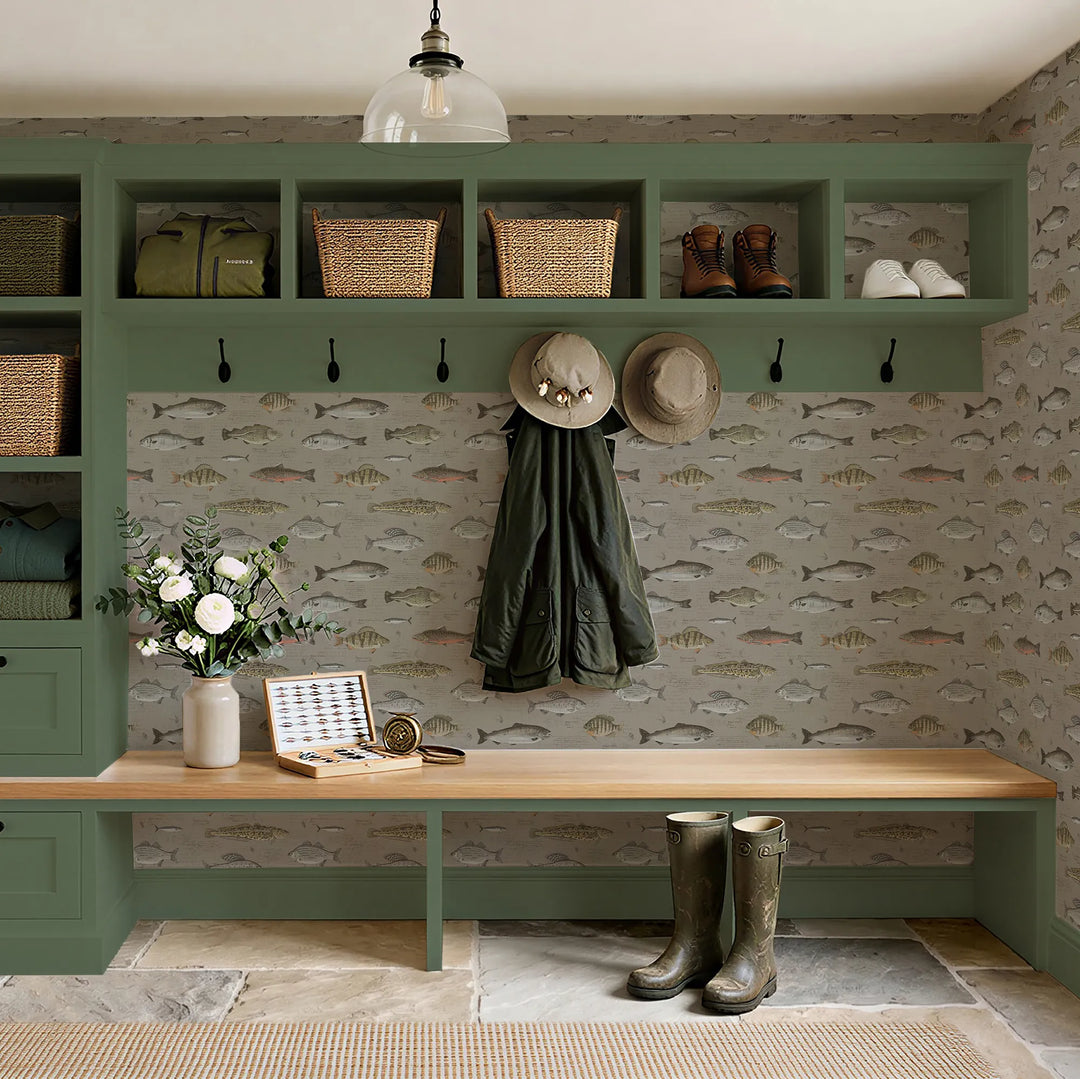 Mudroom setting with green wall storage, wooden bench, and decorative elements.