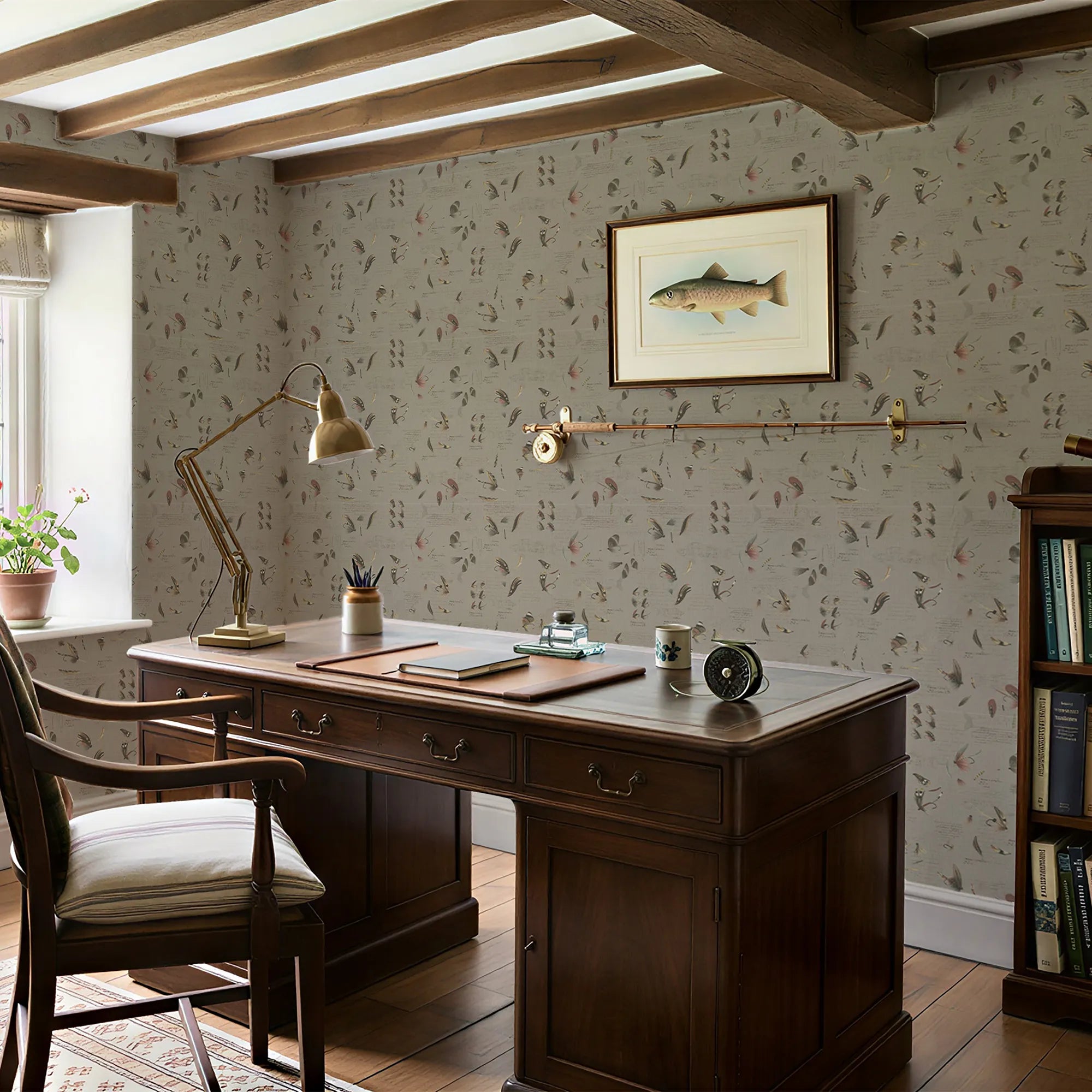 Home office with wooden desk, chair, lamp, and wall art.