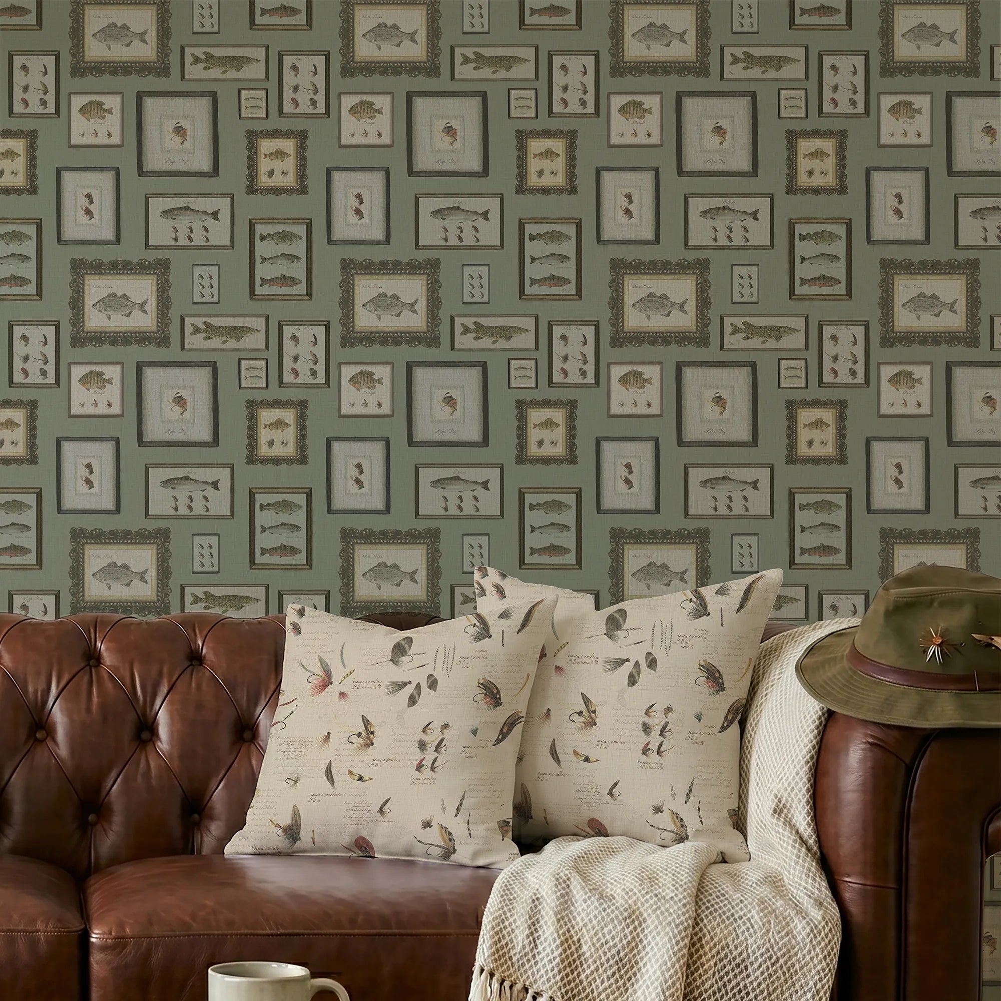Living room with brown leather sofa, patterned cushions, and a wall with framed fish illustrations.