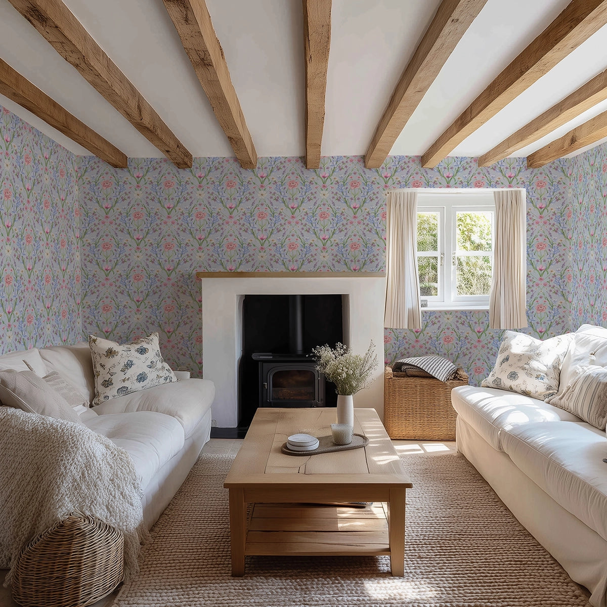 Living room with a large scale, floral wallpaper in light blue, wooden beams, and white sofas.