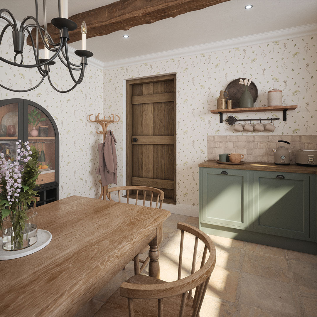 Cottage kitchen setting with oak furnishings and delicate floral wallpaper. 