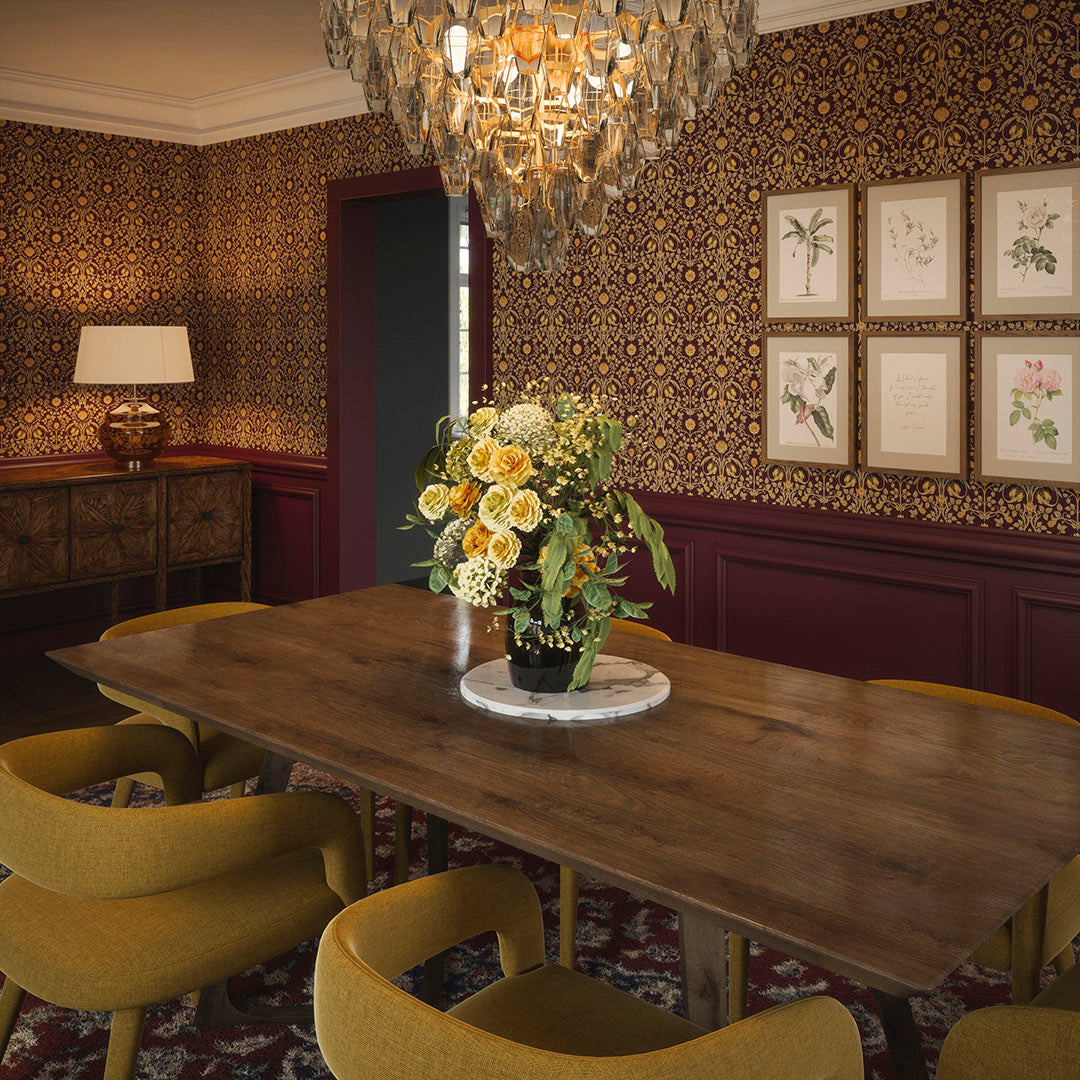 Grand dining room setting with panelled walls in deep red, dining table with flowers in a vase, and wallpaper featuring repeated gold tulips on a deep red background. 