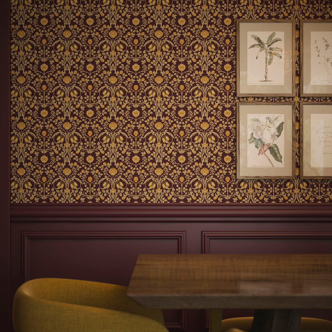 Dining room wall with floral artwork and wallpaper featuring repeated gold tulips and foliage on a deep red background. 