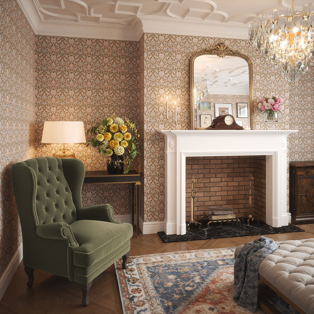 Townhouse living room setting with a fireplace, green grandpa chair, rug, and mirror set aganst a pink wallpaper featuring repeated blue tulips. 