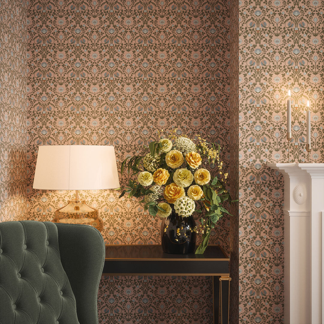 Townhouse living room nook with flowers in a vase, and a lamp set against pink wallpaper featuring repeated blue tulips. 